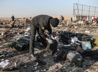 Rescuers search the debris at the crash site.