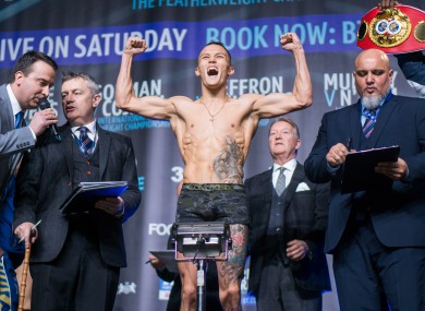 Promoter Warren looks on as Warrington weighs in for his world-title defence against Carl Frampton.
