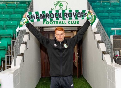 Holding up the Rovers scarf.
