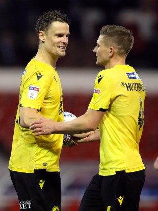 Millwall's Matt Smith greets Shaun Hutchinson during the Sky Bet Championship match at City Ground.