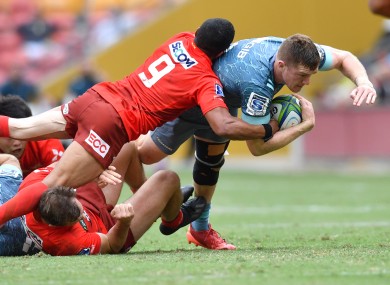 Dallas McLeod of the Crusaders is tackled by Rudy Paige of the Sunwolves.