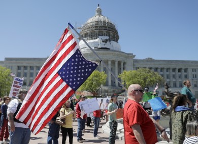 People gather outside the Missouri Capitol to protest stay-at-home orders put into place due to the Covid-19 outbreak.