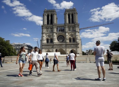 People walk on the forecourt of Notre-Dame's cathedral.