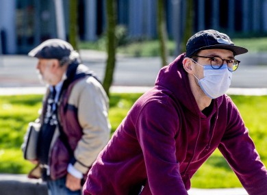 A cyclist wears a face mask in Rotterdam, Netherlands.