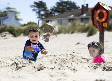 Tyler Byrne (3) and Mollie Murphy (3) from Dublin digging a hole on Burrow Beach in Sutton earlier this week.