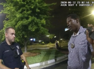 This screen grab taken from body camera video provided by the Atlanta Police Department shows Rayshard Brooks speaking with Officer Garrett Rolfe in the parking lot of a Wendy's restaurant