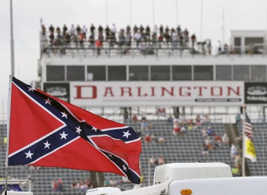 In this Sept. 5, 2015, file photo, a Confederate flag flies in the infield before a NASCAR Xfinity auto race at Darlington Raceway.