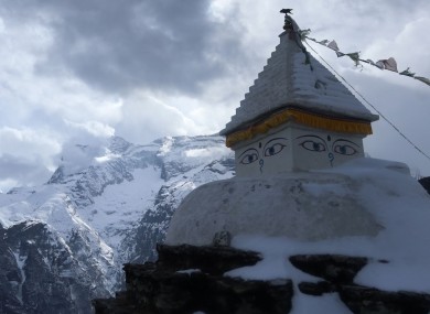 A Buddhist stupa in front of a mountain in the Nepali Himalayas