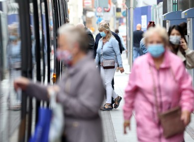 File photo. People wearing face masks entering public transport