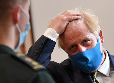British Prime Minister Boris Johnson wearing a face covering yesterday.