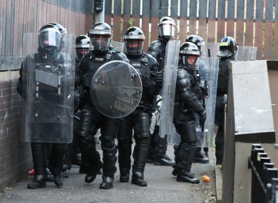 Police Service of Northern Ireland officers in riot gear carry out searches in the New Lodge area of Belfast yesterday.