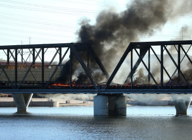 The train is on fire and the bridge has collapsed in Tempe, Arizona.