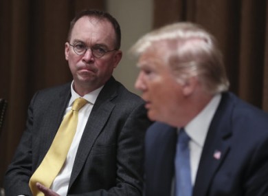 Mick Mulvaney, seated alongside Donald Trump in December 2019.