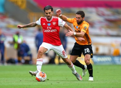 Dani Ceballos holding off Wolves midfielder Joao Moutinho.