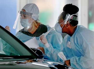 Healthcare workers prepare to collect samples at a testing site at the Miami-Dade County Auditorium.