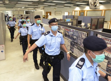 Photo of police during raid at the Hong Kong newspaper.