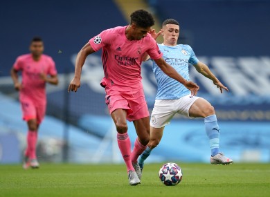 Real Madrid's Raphael Varane (left) and Manchester City's Phil Foden battle for the ball.