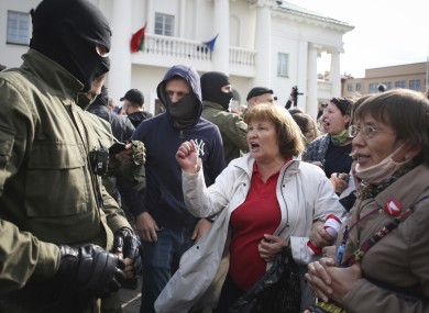 A woman shouts standing in front of police line during a protest in Minsk today.
