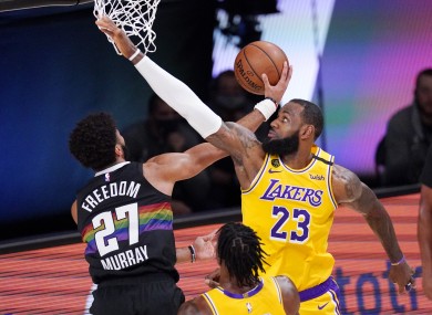 Jamal Murray attacks the rim, guarded by LeBron James.