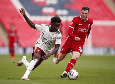 Arsenal's Bukayo Saka being tracked by Liverpool's Andy Robertson during the Community Shield.