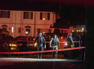 Police officials work at a scene when the man was shot.