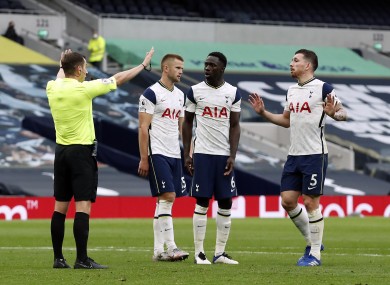 Tottenham Hotspur players surround referee Peter Bankes after he awards a penalty at the weekend.