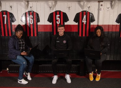 Direct Provision residents Sharron Moyr (left) and Jackie Sibanda (right) with Bohs' Danny Grant at Dalymount Park.
