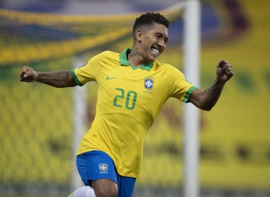Roberto Firmino celebrates after scoring against Bolivia.