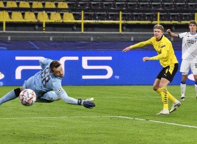 Haaland looks on at his goal-bound shot against Club Brugge.