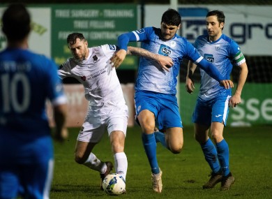 Finn Harps' Kosovar Sadiki and Waterford's Daryl Murphy battle for possession on Monday night.