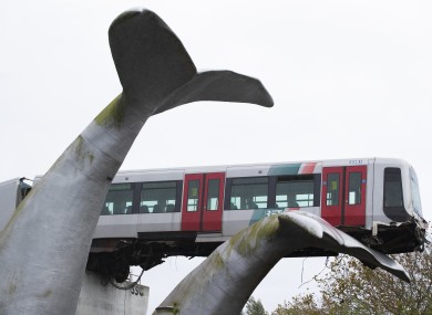 The whale’s tail of a sculpture caught the front carriage of a metro train as it rammed through the end of an elevated section of rails with the driver escaping injuries in Spijkenisse.