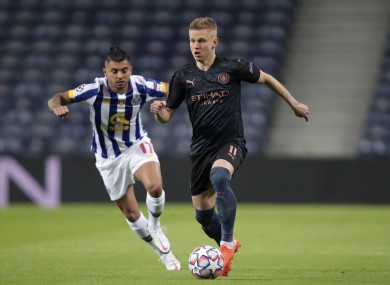 Manchester City's Oleksandr Zinchenko runs with the ball away from Porto's Jesus Corona.
