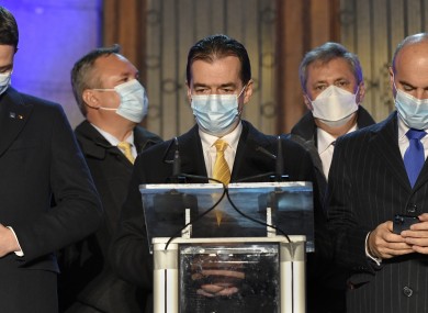 Romanian Prime Minister Ludovic Orban (centre) waits for exit polls in Bucharest yesterday.
