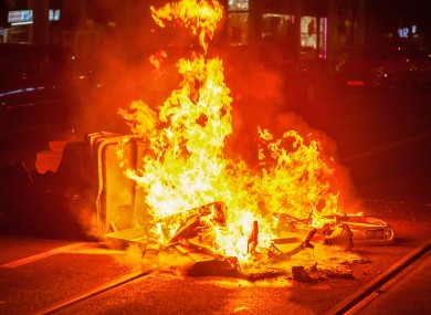 A rubbish container and bicycles are seen burning on the street in The Hague last night.