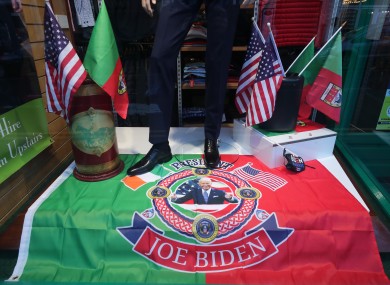 A window display with a flag showing President-elect Joe Biden in a men's clothing shop in Ballina, Co Mayo.