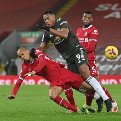 Liverpool's Fabinho (left) and Manchester United's Anthony Martial battle for the ball.