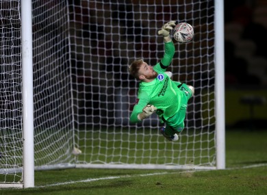 Jason Steele saves a penalty kick from Newport County's Josh Sheehan.