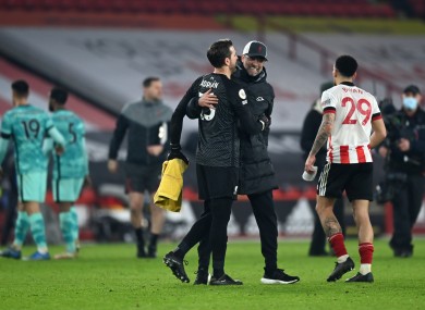 Jurgen Klopp celebrating with Liverpool goalkeeper Adrian after the final whistle.