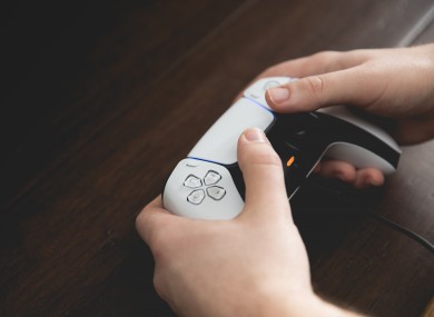 File photo of a man holding a PS5 control