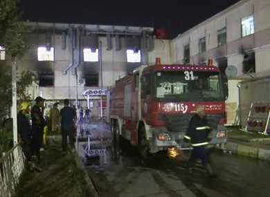 First responders work the scene of a hospital fire in Baghdad.