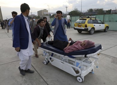 An injured school student is transported to a hospital after a bomb explosion in Kabul