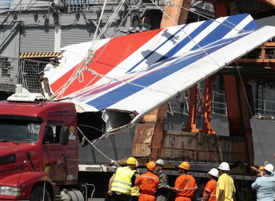File photo shows workers unloading debris, belonging to crashed Air France flight AF447, in the port of Recife, northeast of Brazil.