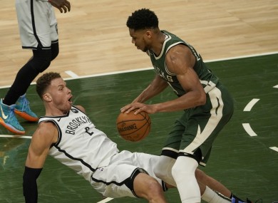 Brooklyn Nets' Blake Griffin draws a charge on Milwaukee Bucks' Giannis Antetokounmpo.