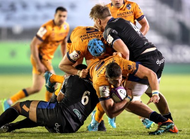 Montpellier's Paul Willemse is tackled by Taulupe Faletau of Bath.