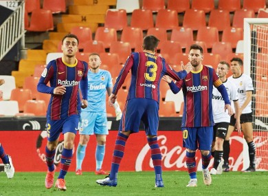 Lionel Messi, Gerard Pique and Sergino Dest celebrating a goal against Valencia.