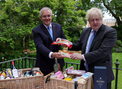 Boris Johnson and Australian Prime Minister Scott Morrison exchange biscuits at a photo opp in Downing Street