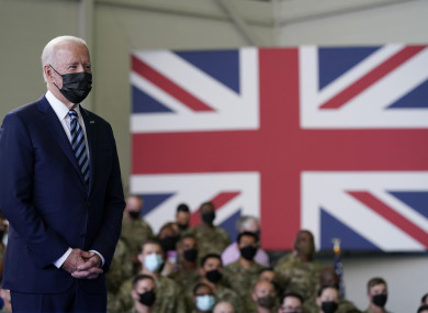 President Joe Biden listens as first lady Jill Biden speaks to American service members at RAF Mildenhall in Suffolk, England.