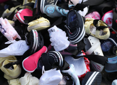 Baby shoes with black mourning ribbon were laid on the railings of the Commission's office in February in protest.