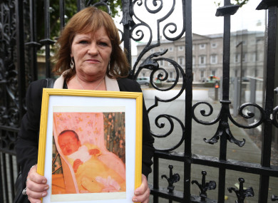 Terri Harrison pictured with a photo of her baby Niall, at a protest outside Leinster House in 2014.