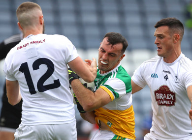 Neil Flynn and Eoin Doyle tackle Colm Doyle.